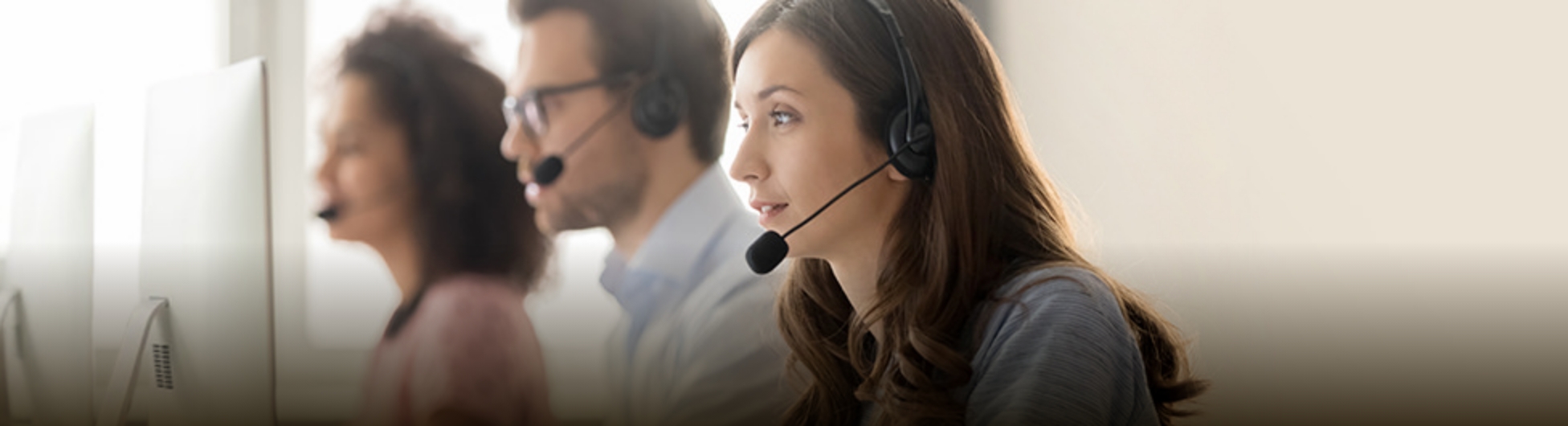 An image of a male and female operator wearing an intercom and responding to a call
